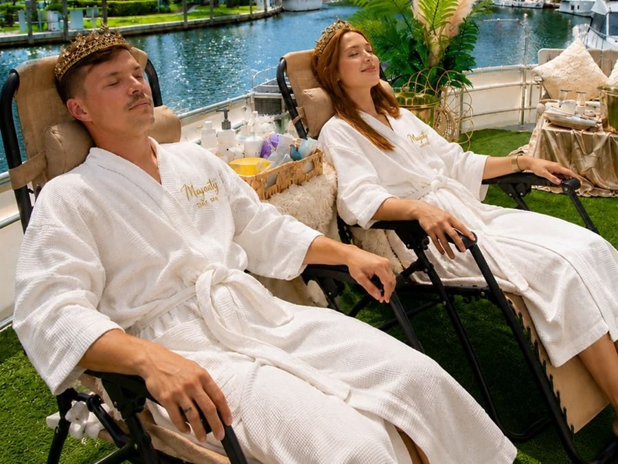 A couple in Majesty robes relaxing side by side in lounge chairs
